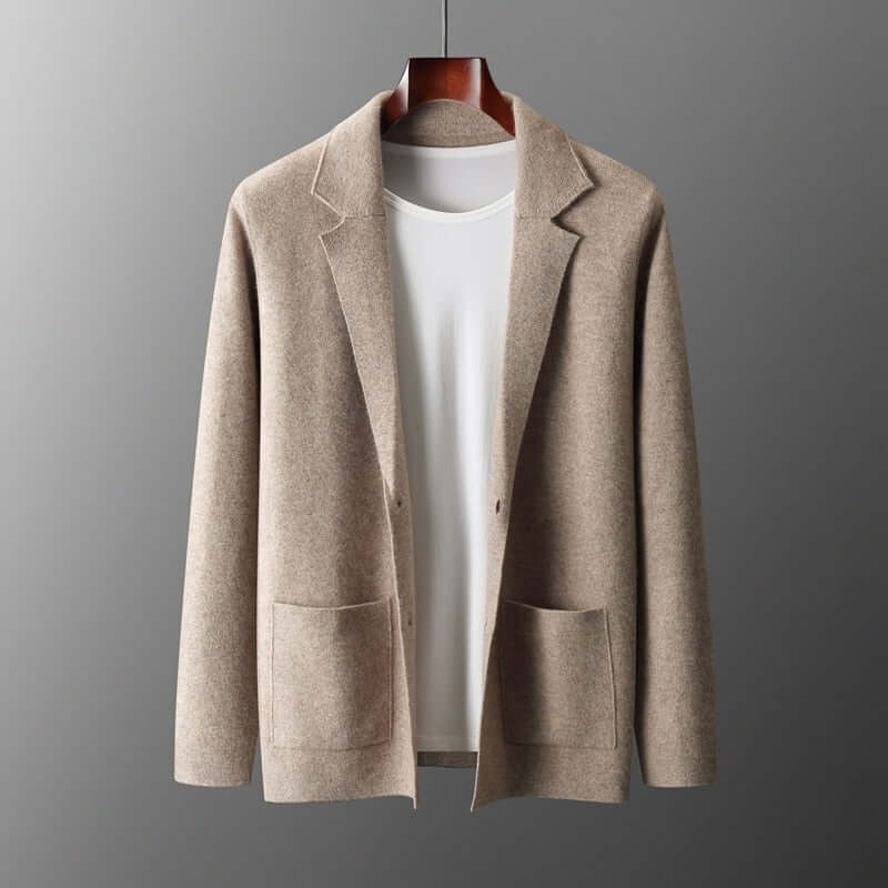 ELIJAH Chic Blazer in beige hanging against a gray background, highlighting its modern design and timeless elegance.