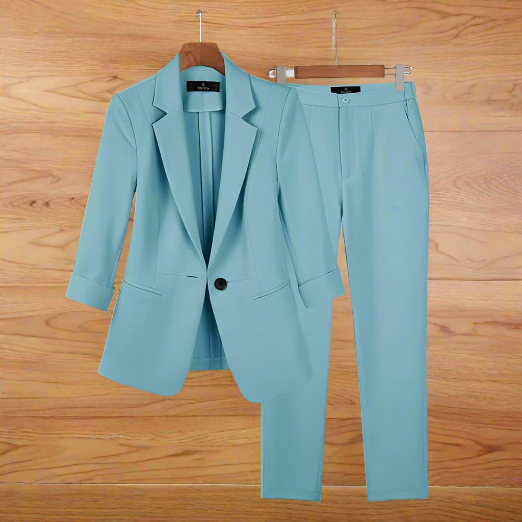 Light blue Melanie Premium Suit for women on hanger, showcasing elegant blazer and pants for confident style.