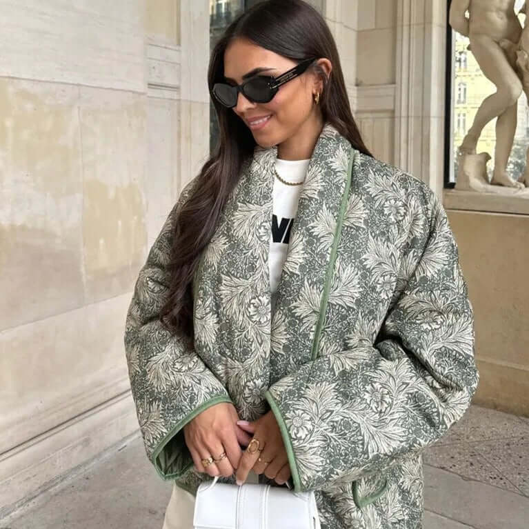 Stylish woman wearing the Swannie Jacket, ideal autumn fashion for warmth and elegance, posed in a classic architectural setting.