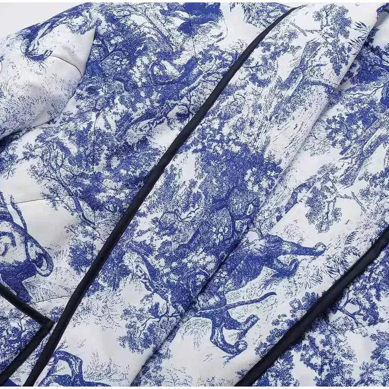 Close-up of Swannie Jacket with intricate blue and white forest pattern, showcasing detailed design and craftsmanship.