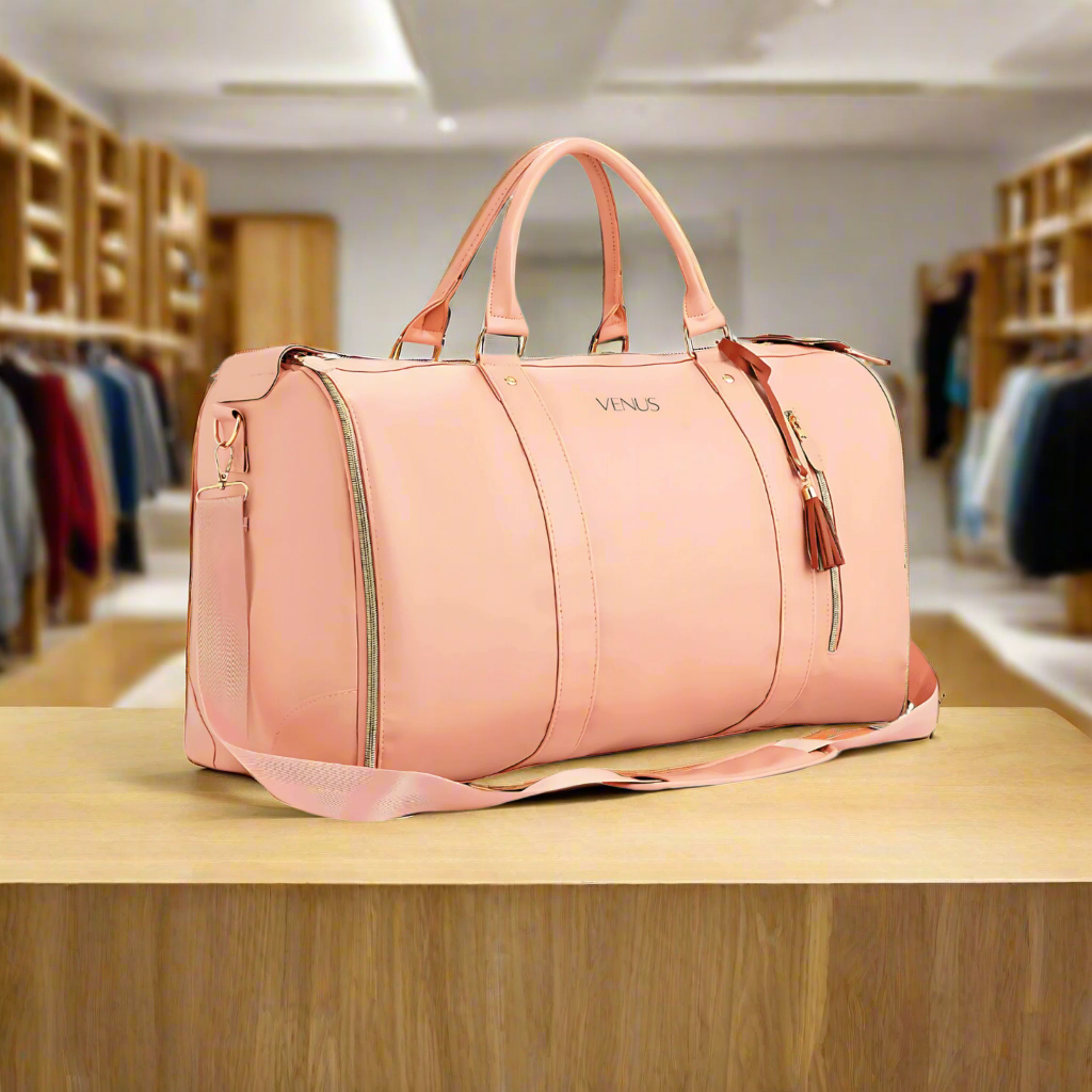 Luxurious pink VENUS travel bag with sleek design and adjustable strap, perfect for organized and stylish travel.
